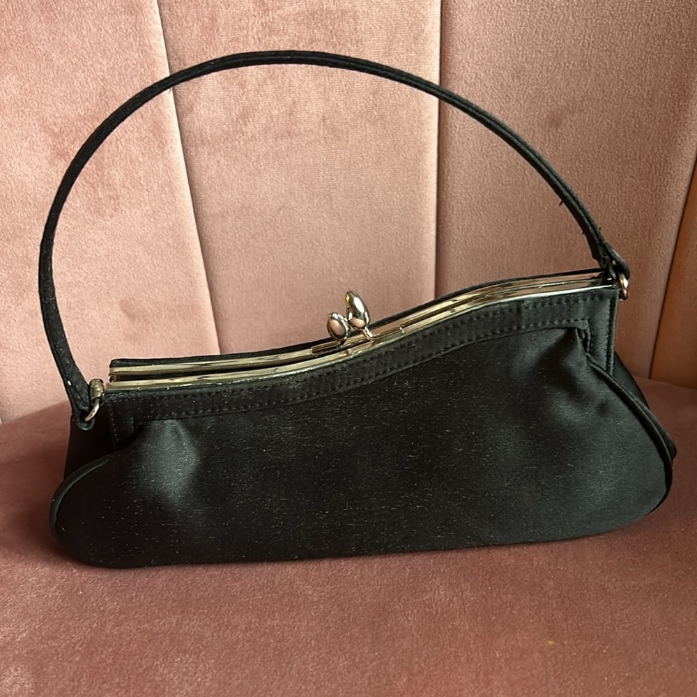 Black asymmetrical sloping kiss closure formal event purse.